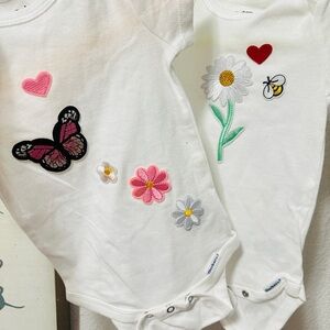 White Baby Onesies with Floral and Heart Designs
